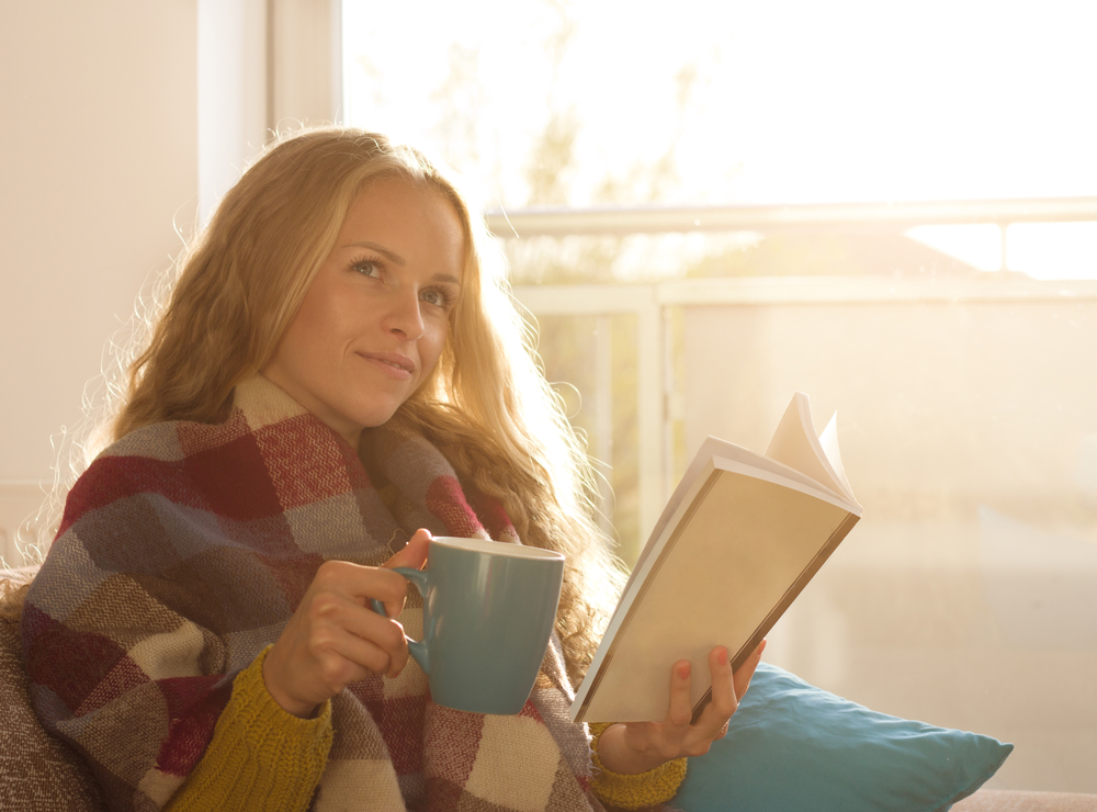 Young Woman Enjoys the Natural Light of a Window